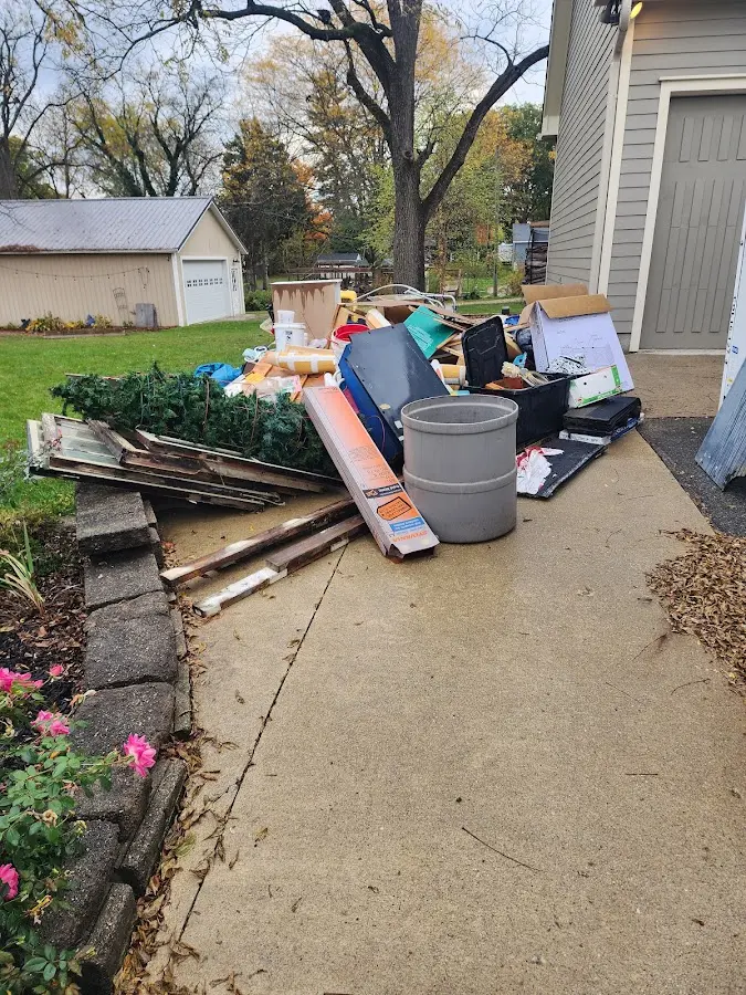 Dumpster being loaded with debris for Estate Cleanout Dumpster Rental in Lawrence